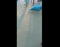 Boy slides down slide falls down