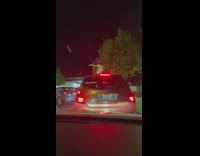 Woman in red cowboy hat screams on the car roof