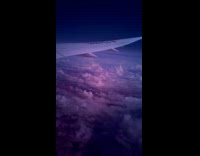 Purple clouds filmed landscape during plane ride