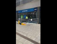 Guy cleans up broken gymgroup glass window