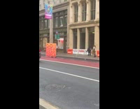 Collab WINY - Person carry large sign with text draw