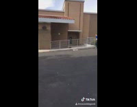 Girl blue shirt runs and jumps over rail the falls down, slow motion