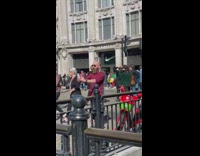 Bald man balances crystal ball on top of his head
