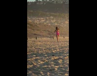 Woman pink bikini model walk beach sunset