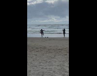 Person stands on one leg balances beach 