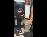 Guy green hat beret pizza trashcan