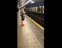 Man red shoes feeds pigeon walking in subway station