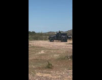 guy sits on jeep roof fires gun 