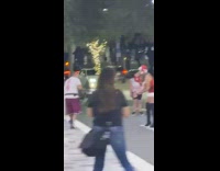 Woman in a Santa costume rap video shoot at the park