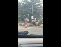 Woman in black tank top tiktok dance at the parking lot