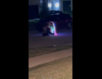 Woman lit dress poses on the street