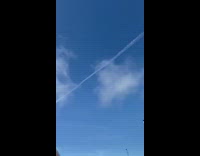 Contrail in sky snow mountain white house