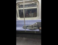 Guy inside the train lay on the seat while travel 