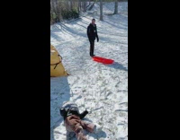 Baby falls off red snow sled 