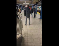 Two guys play table tennis on subway station floor