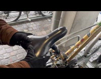 Mans bike seat covered in ice 