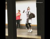 Guy white long coat dancing subway platform headphones 