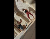 Woman red leggings photo shoot brick wall