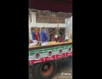 Kid on truck bend over and starts dancing