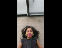 Girl spins pink fidget spinner over mouth