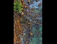 Aerial view above rocky beach 