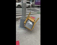 Crossing sign hanging on by a thread on the floor