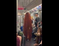 Person stands at train full of hair
