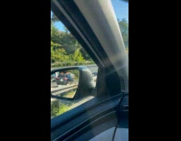 Rescuers retrieving crashed car on expressway