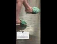 Woman sits with monster slippers 