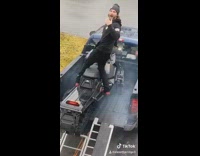 Snowmobile ramp fail guy grey beanie truck