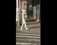 Man wears white costume walk at street in NY 