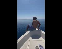 Guy jumps off white boat rides whale 