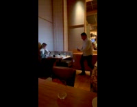 Woman sexy poses with drink inside restaurant