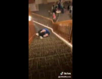 Blue sweater guy purposely falls down stairs 