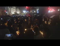 People in circle at vigil showing solidarity for victims and protests
