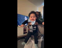 Mom carries baby to dance little hands