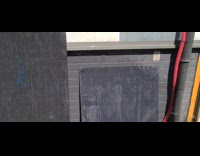 Water from hose sprinkled and reveals a small rainbow at the backyard