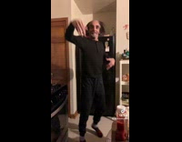 Guy in all black outfit with middle bald spot dancing 