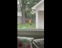 Yellow shirt guy dances backyard grass window 