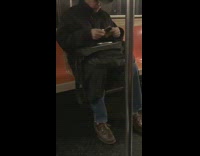 Man in cowboy hat takes out portable CD players and listens to music on subway train