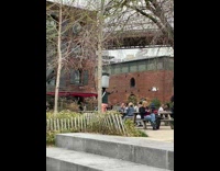 Biker balances large trashcan on head 