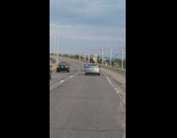 White shirt guy dances silver car sunroof 