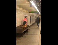 Woman in pink poses on train bench 