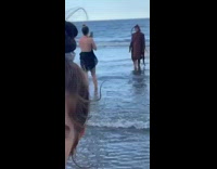 Girl cockroach bug costume dances ocean water 