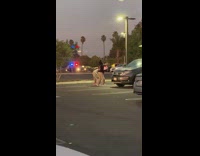 Two girls dance bend over at parking lot