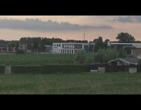 White building alarm goes off siren sunset