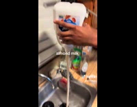 Pouring almond milk into sink