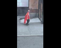 Man wear blue eye mask and red cape