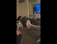 Guy falls backwards on chair and his head