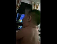 Shirtless baby boy watch tv wave its arms